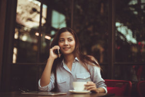 Asian woman drinking coffee in vintage color tone